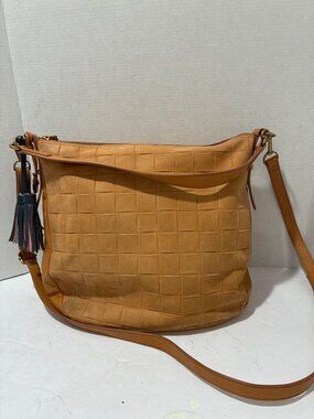 Fossil Jolie woven tan leather hobo bag with a blue tassel accessory crossbody